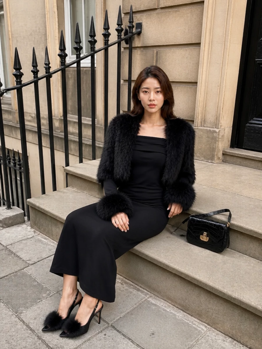 I’m anchoring the outfit with the off-shoulder faux-fur cuffed maxi rather than top and mini, so the Yves Salomon cropped jacket sits over a long, uninterrupted black column instead of clashing with another short hem. The result is a high-impact, fur-detailed evening ensemble where the drama is concentrated at shoulders, cuffs and shoes, edited with a sharp black croc bag to keep everything feeling intentional and polished. Think winter party dressing that is unapologetically plush but still reads grown-up and sculpted rather than costume.