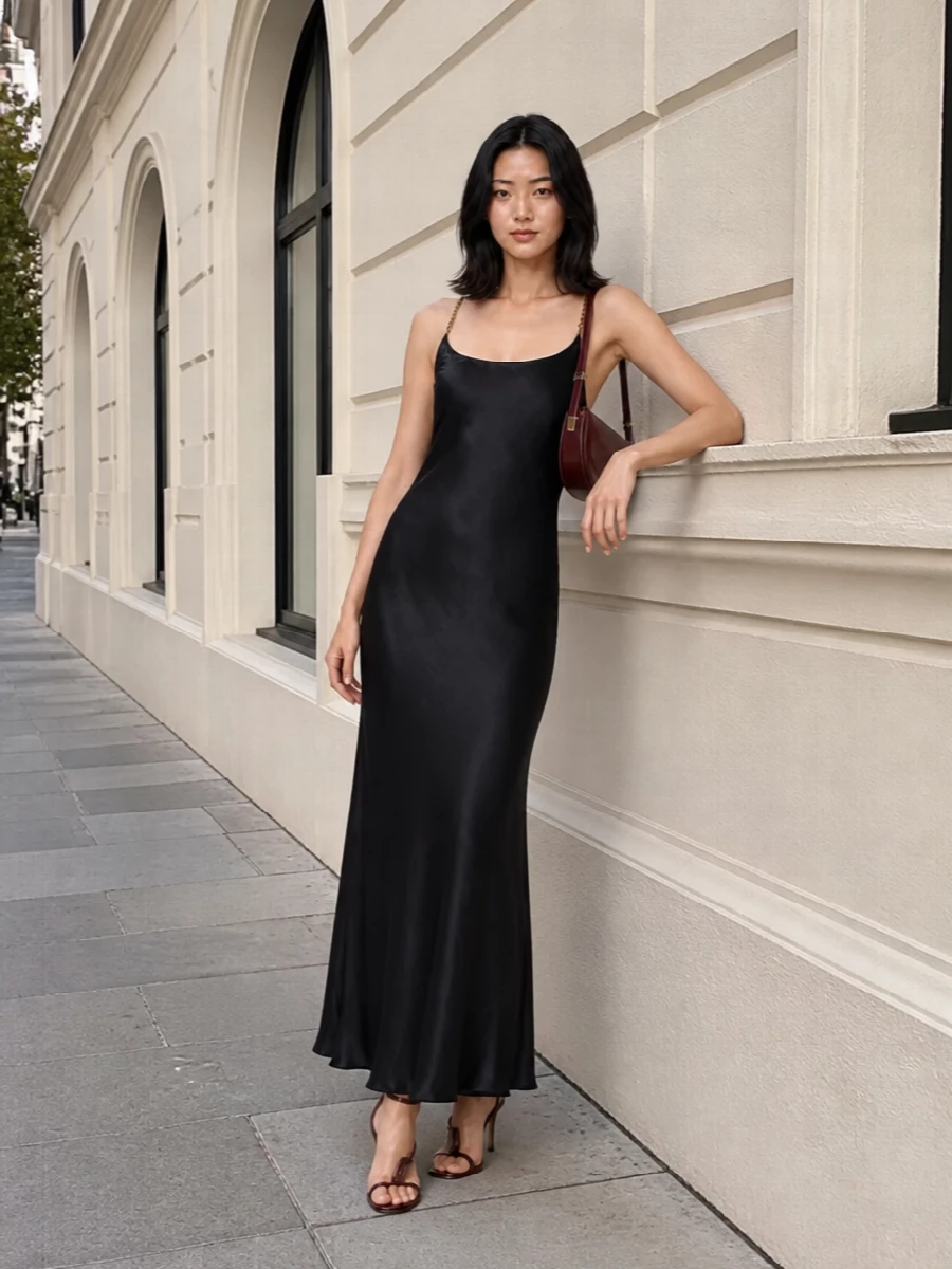 I anchored this with the satin slip dress rather than separates, so the sandals can trace one continuous, romantic line down a dark column of fabric. Burgundy accessories stay close to the oxblood tone without feeling too matchy, giving depth and a very quiet kind of glamour. The result is a long, fluid evening silhouette that reads polished, sensual and completely composed for winter nights out.