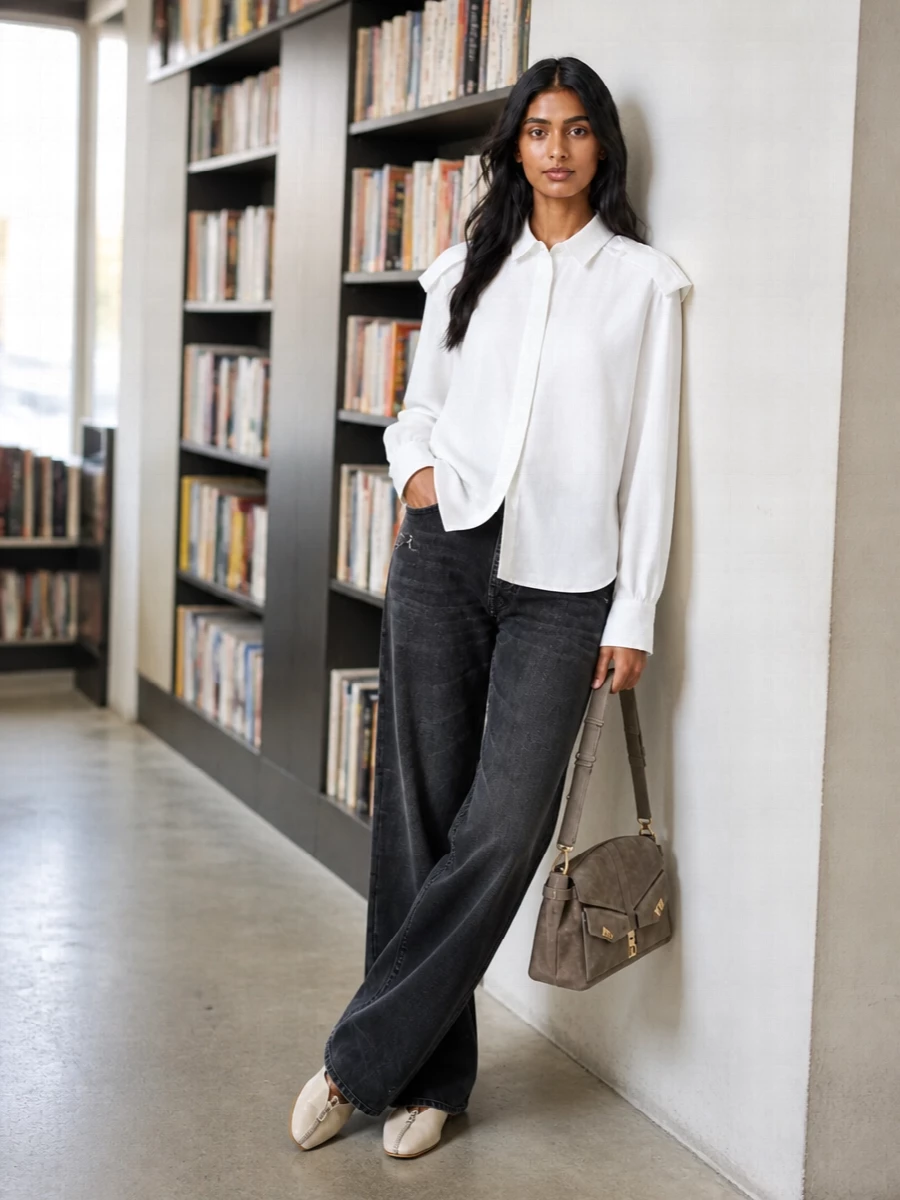 Washed-black Gucci denim meets a crisp Burberry longline shirt for a clean, elongated silhouette that reads relaxed but intentional. Pale Burberry flats keep the line modern and low-key, while a taupe Ferragamo shoulder bag adds a soft, tonal accent that stays firmly in the quiet luxury space. The result is a city-ready uniform that slips easily from late morning errands to an early dinner reservation.