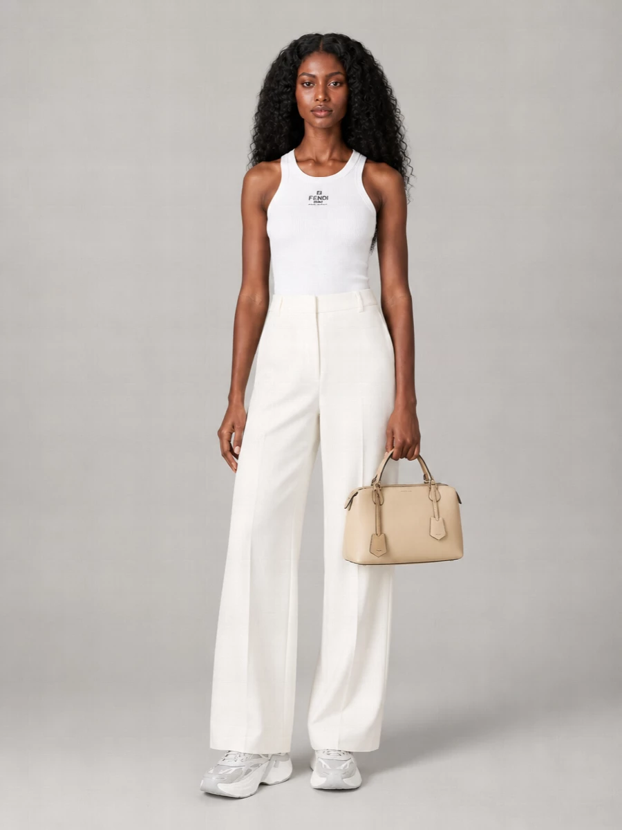 This outfit leans into the sneaker’s sculptural, technical energy with a crisp white ribbed tank and soft ivory wide-leg trouser, keeping everything long, clean and quietly athletic. The palette stays in cool neutrals and warm creams so the shoe reads as a graphic highlight rather than a distraction. The bag adds just enough structure to keep it city-ready while preserving an easy, sport-luxury attitude.
