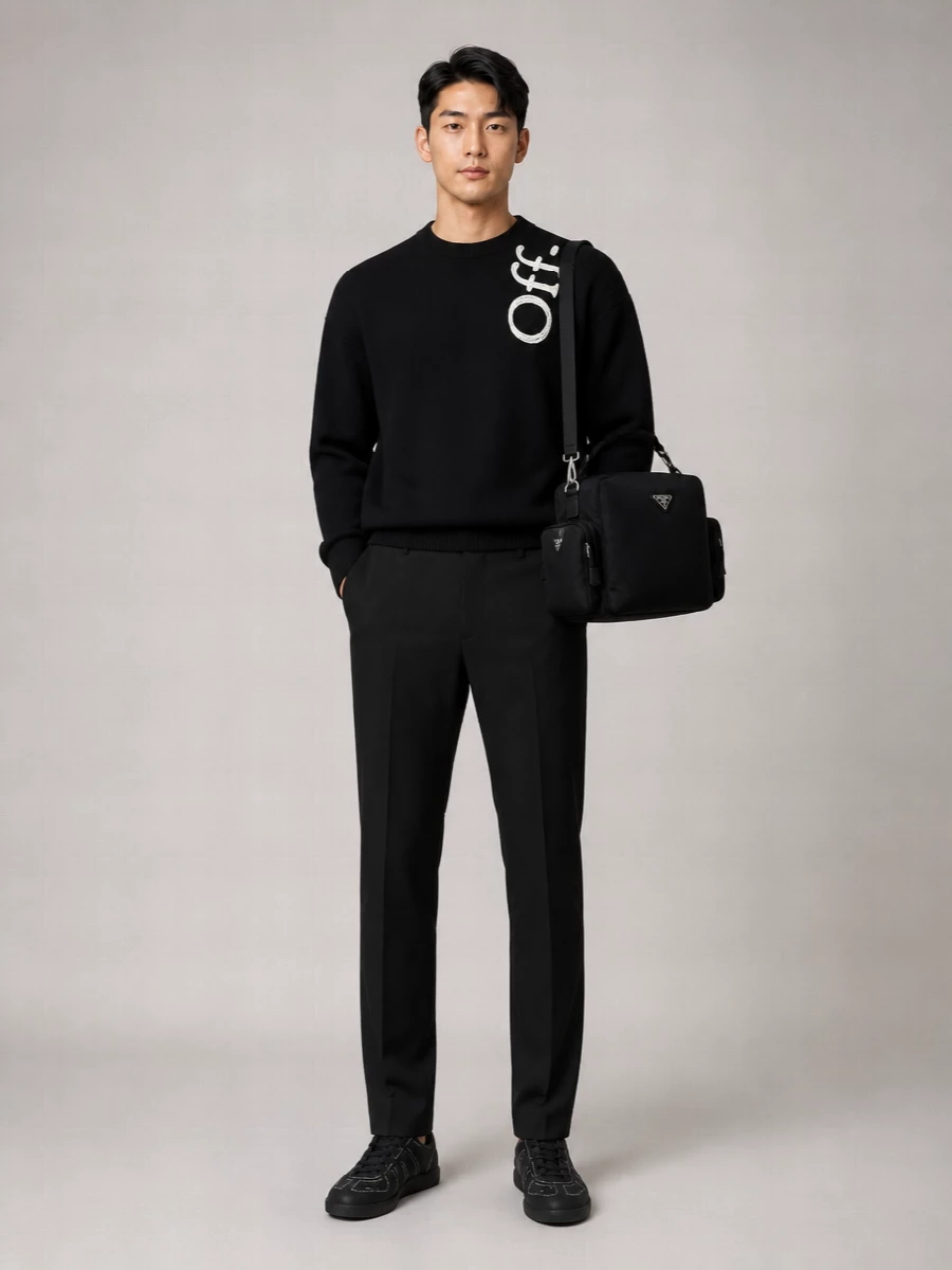 Off-White’s graphic crew sits over precise black straight-leg trousers for a monochrome streetwear uniform that reads clean rather than shouty. Margiela’s stitched black sneakers quietly echo the neckline detail, and Prada’s structured nylon crossbody adds a technical note that keeps the whole combination sharp and urban-ready.
