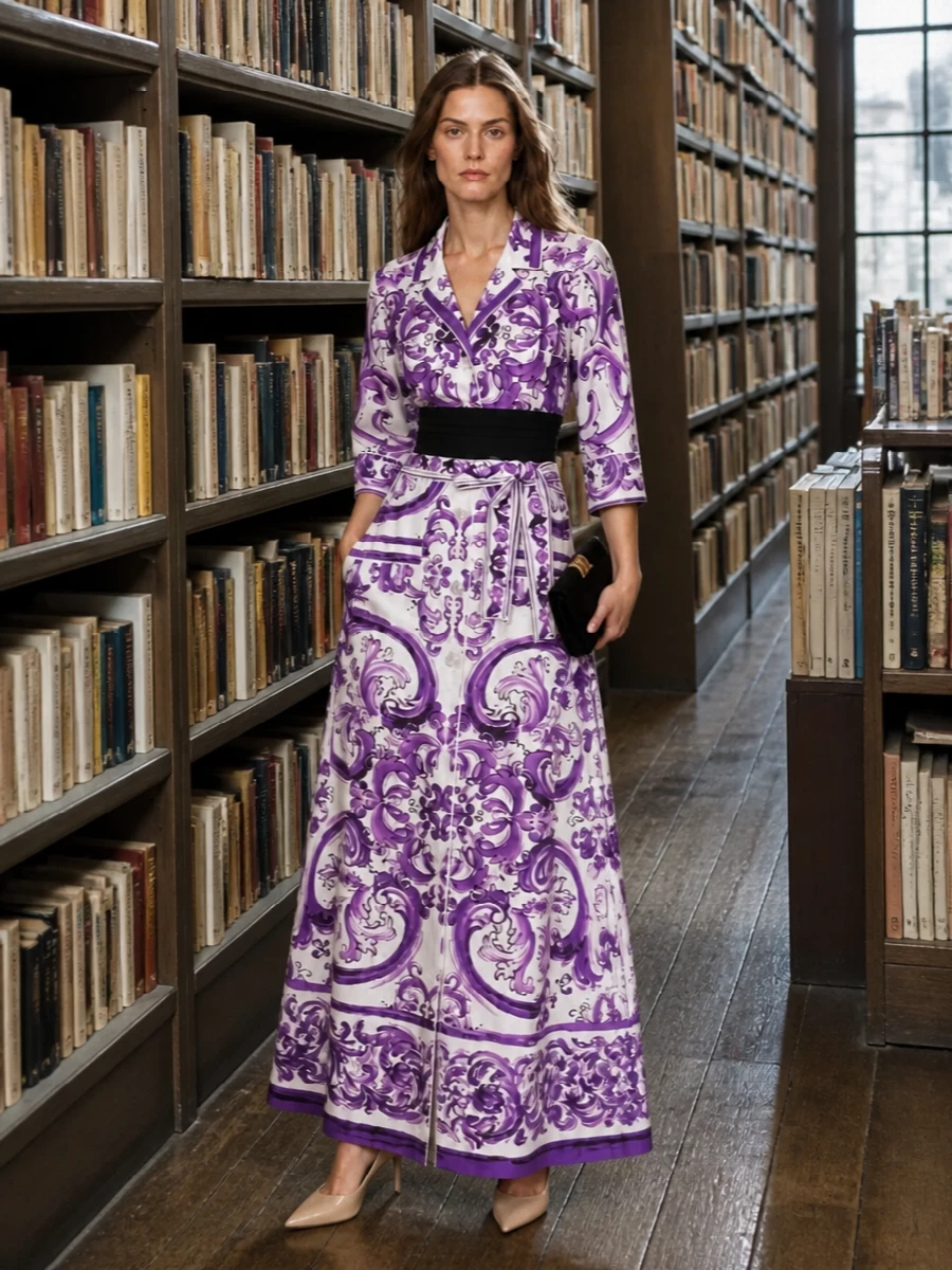 Dolce&Gabbana’s violet scroll maxi takes centre stage, cinched with a structured black waist belt for a sharper, corseted line. Nude stilettos lengthen the silhouette while disappearing tonally, so the print reads uninterrupted. A black velvet clutch adds just enough rich texture and gold hardware for gallery openings, winter dinners, or polished cocktail evenings.