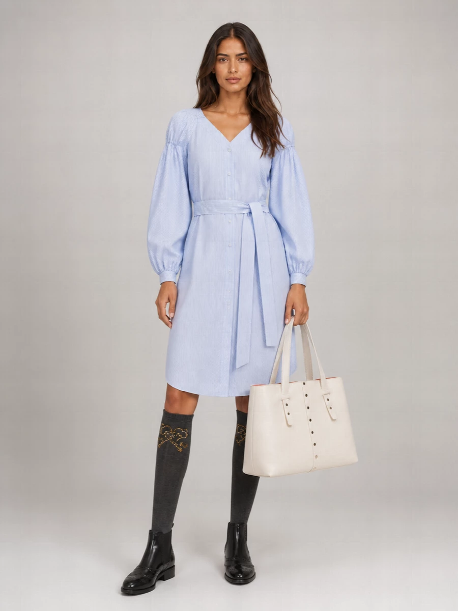 This is a quietly polished, collegiate take on Dolce&Gabbana’s baroque knee-high socks, styled for real daytime life. The striped Stella McCartney shirtdress, brogue ankle boots and structured ivory tote keep the mood preppy and intelligent, with the charcoal socks peeking out as a subtle heritage detail rather than a costume note. I chose the dress path over top and leggings because it preserves a clean A-line silhouette that lets the socks and boots do the talking without the outfit feeling overworked or overly body-conscious.
