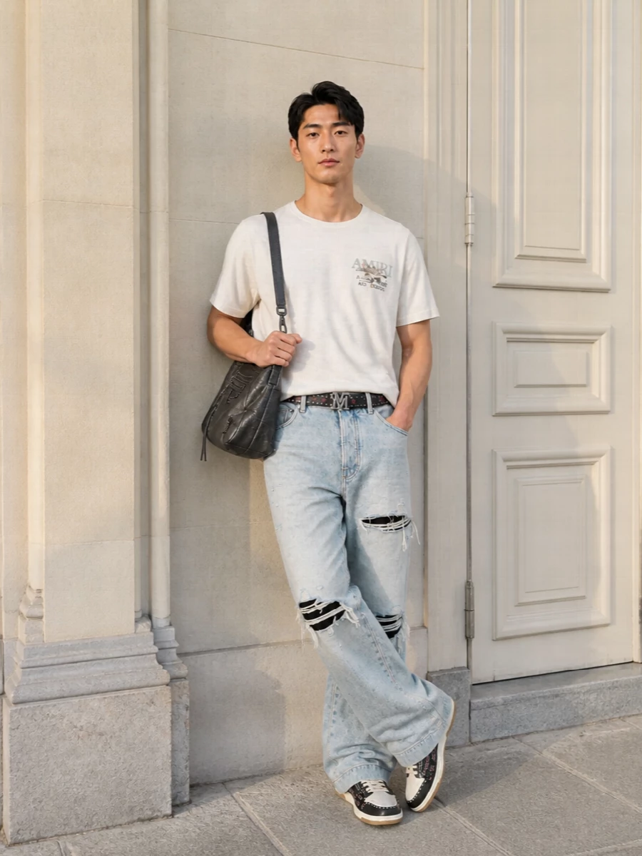 Lightly destroyed Amiri denim sits with an off white logo tee for a soft, LA-daytime take on rock styling. Studded low tops and a slouched Balenciaga shoulder bag push it into full y2k street energy, while the matching Amiri belt quietly locks the attitude together. The result is relaxed and wide in the leg but tight in the details, built for long days that roll straight into late nights.