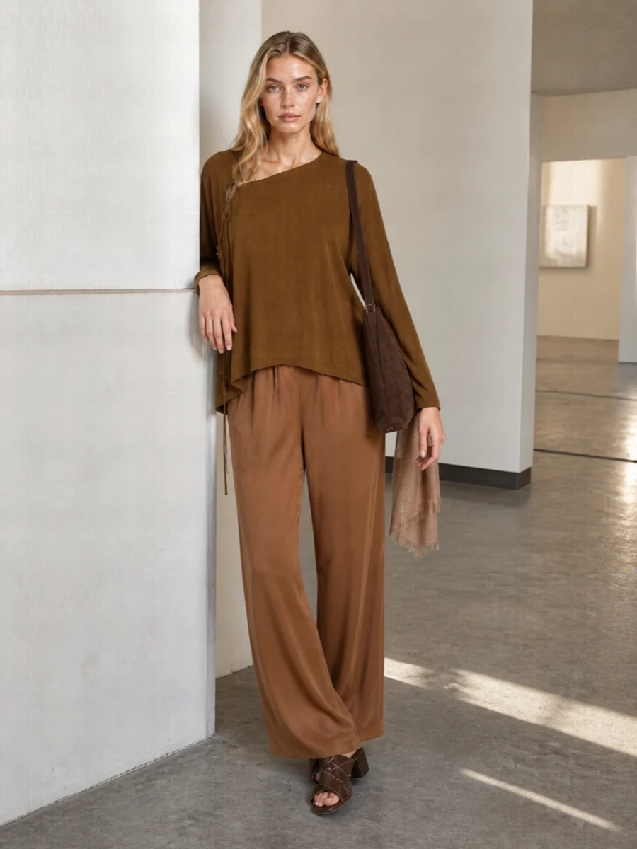 Tobacco and caramel sit tonally together here, the loose Uma Wang blouse and fluid Fabiana Filippi trouser creating one long, easy column. Dark chocolate mules and a suede tote quietly sharpen the palette, while a gauzy rose-tan scarf adds just enough softness. The result is relaxed but intentional, ideal for warm days when you still want nuance and polish in your neutrals.
