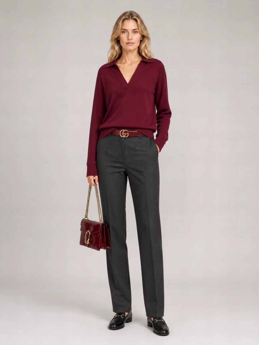 Burgundy and charcoal anchor this outfit in a quietly confident palette that feels right for city days and low-key dinners. The collared knit and sharp high-rise trouser create a long, clean line, finished with black loafers and a structured burgundy bag for a polished, grown-up finish. A slim tonal belt is the only accent, keeping the whole composition minimal and precise.