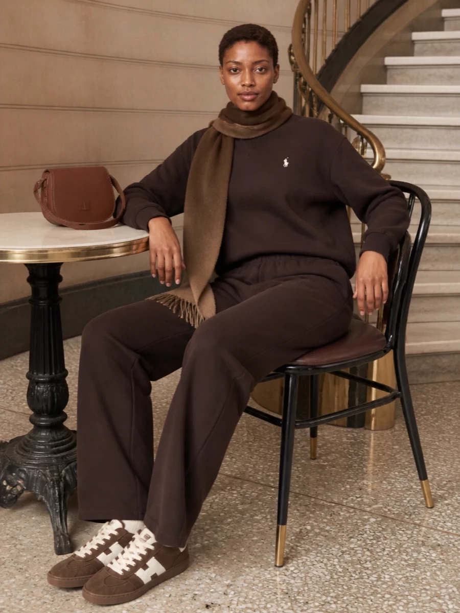 Deep chocolate layers keep this set calm and grounded, with the straight-leg knit giving loungewear a more considered line than classic cuffs. Cream notes in the sneakers and chestnut leather bag lighten the mood just enough for coffee runs and travel days without breaking the quiet palette.