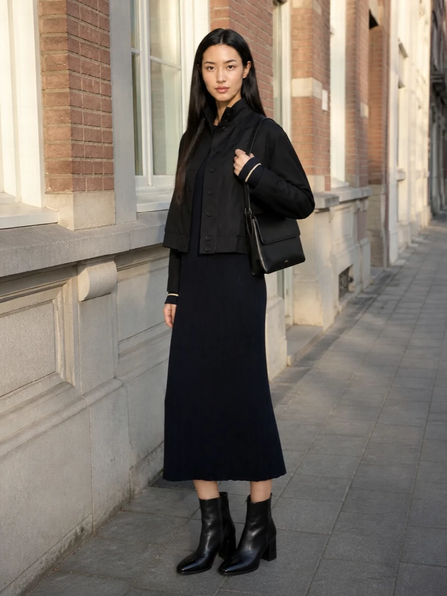 I am taking the dress path here, letting a single, sculpted knit column underpin the cropped Our Legacy coat rather than breaking the line with separate top and trouser. The S Max Mara navy ribbed dress keeps everything long and vertical under the boxy jacket, while the polished Carel boots and structured A.P.C. bag deliver a composed, dinner-or-gallery-ready finish that still feels relaxed enough for daytime. The palette stays inky and restrained so the interest is in proportion and texture, not noise.