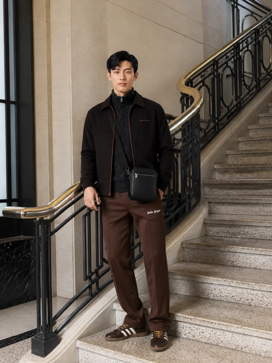 Deep chocolate and charcoal sit at the core here, giving a rich, athletic set that feels calm rather than loud. The straight-leg track pant and half-zip balance ease and structure, while the terrace sneaker and compact crossbody keep it city-ready from coffee runs to casual dinners. It is sport-influenced, but the darker palette and neat fits push it firmly into grown-up streetwear.