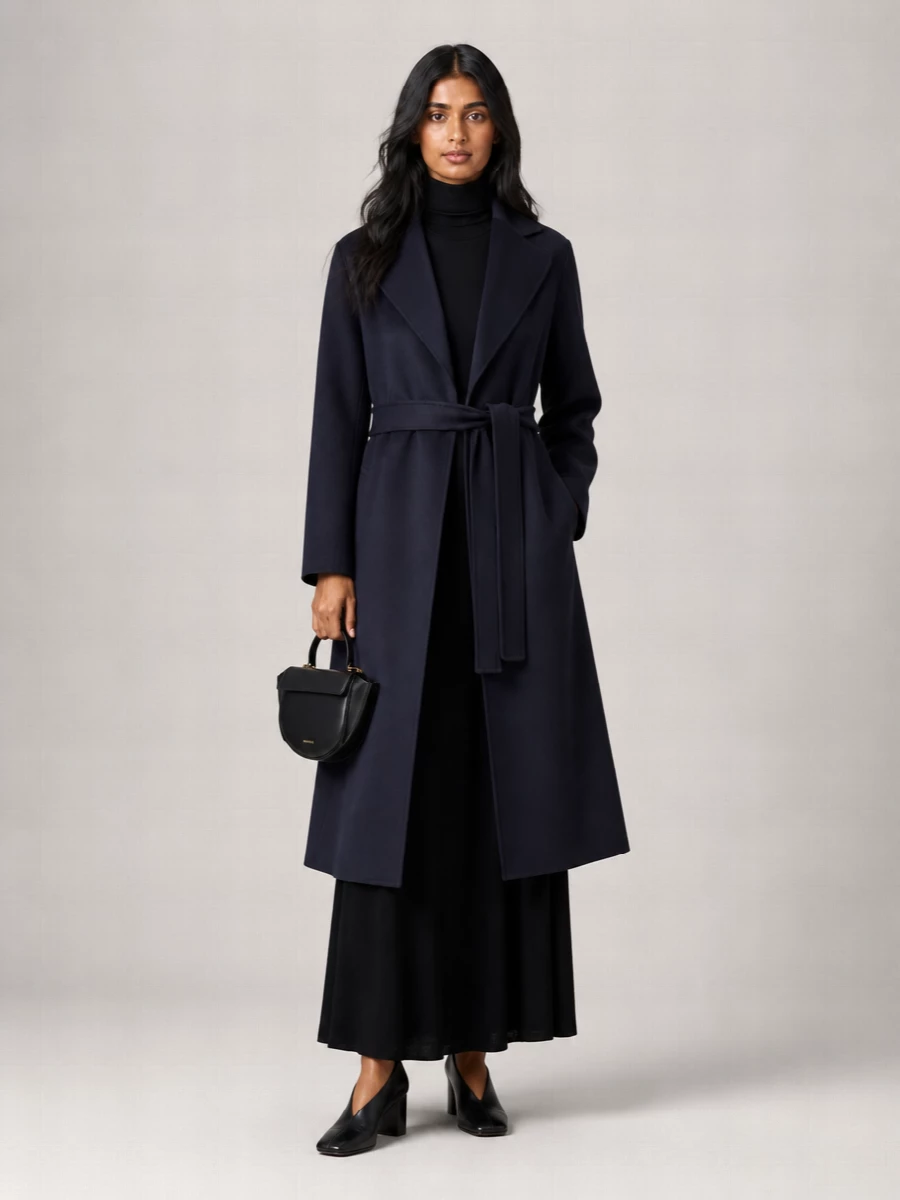 I am building around the dress path, using the ink-black turtleneck maxi as a seamless extension of S Max Mara’s navy wrap coat for a tall, columnar silhouette. Black sculpted pumps and a compact Wandler saddle bag keep the mood boardroom-ready yet dinner-appropriate, maintaining a strict, tailored palette with just enough architectural detail. The result is a quietly assertive city ensemble that reads intentional from morning meetings to late-night reservations without ever feeling over-styled.