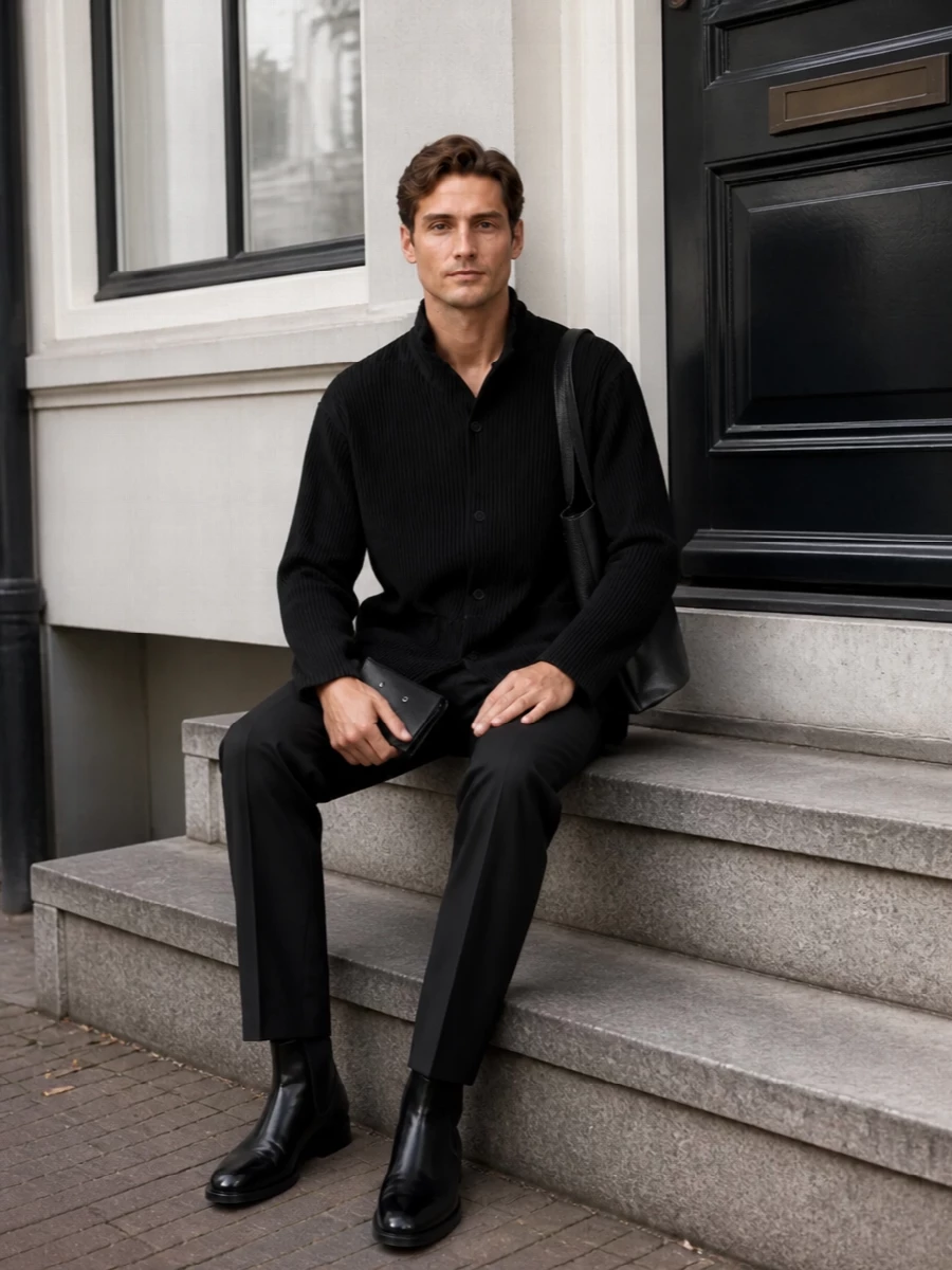 A calm, monochrome city uniform built around considered texture and line, from pleated architectural shirting to razor-clean tailoring. The Jil Sander boots and structured tote keep the profile sharp without visible branding, letting the Margiela wallet whisper at closer range. It is quiet luxury for long days that move between studio, office and late dinners without a change of pace.