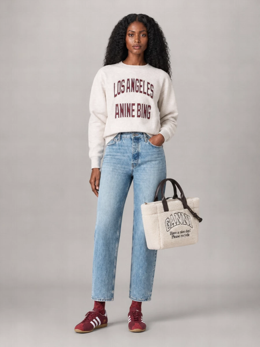 Collegiate LA energy, softened in heathered oatmeal and washed light blue denim, stays grounded with straight lines and easy volume. Burgundy hits repeat through the graphics, sneakers and socks so the colour story feels intentional, not matchy. The fleece tote brings one playful varsity texture into the mix, keeping the whole outfit relaxed and city ready.