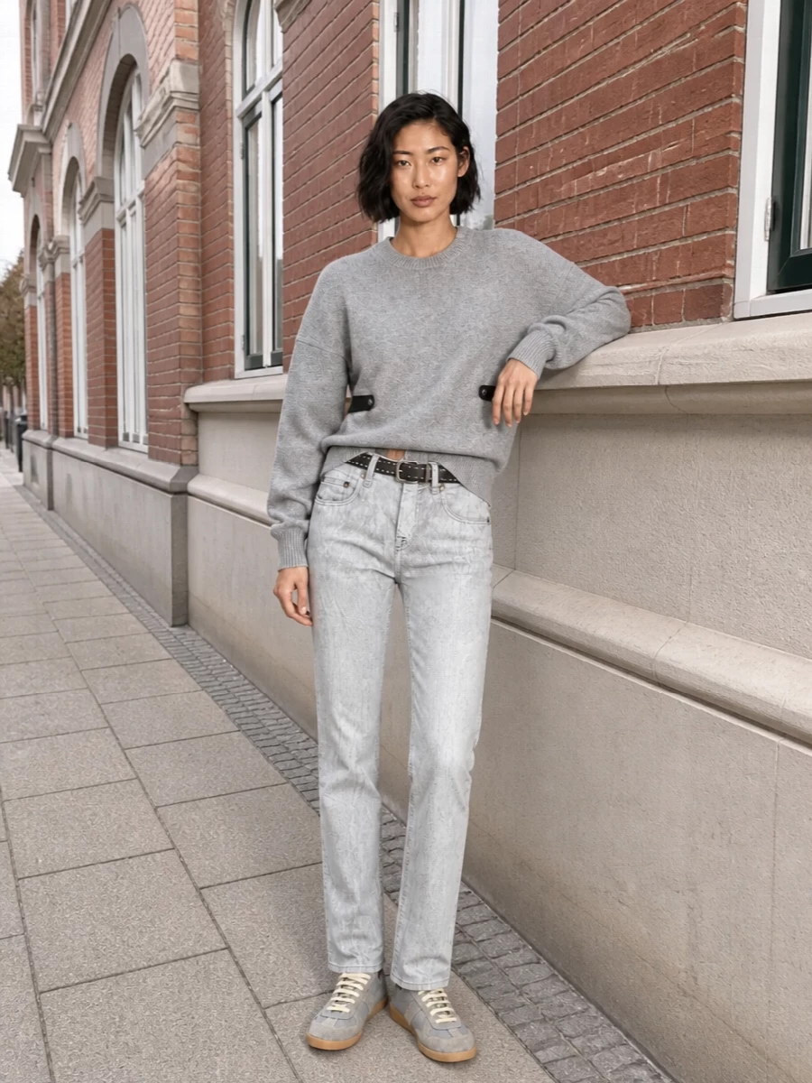 Ice-grey R13 denim meets a structured Alexander Wang crew for a monochrome street uniform that feels precise rather than precious. Margiela’s tonal sneakers keep things low-key and agile, while a sharp Balenciaga mini tote and a slim Prada belt bring just enough hardware to nod to the city without tipping into drama.