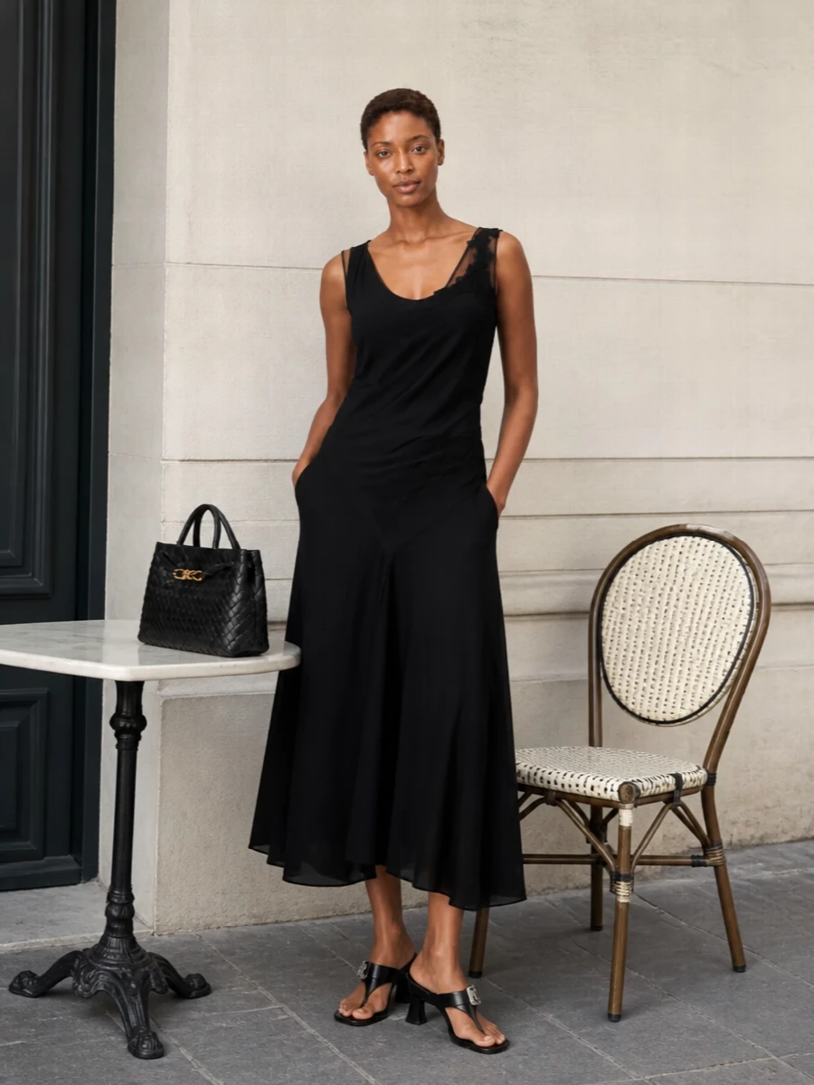This is a quietly decisive evening ensemble built around a sculpted black midi dress and the architectural Bottega tote. The shared black base and clean lines keep the focus on cut and texture, while subtle gold accents echo the bag’s knot hardware for a coherent, modern cocktail mood. I chose the dress route rather than separates to keep the message razor-focused and let the bag function as the single structural counterpoint.
