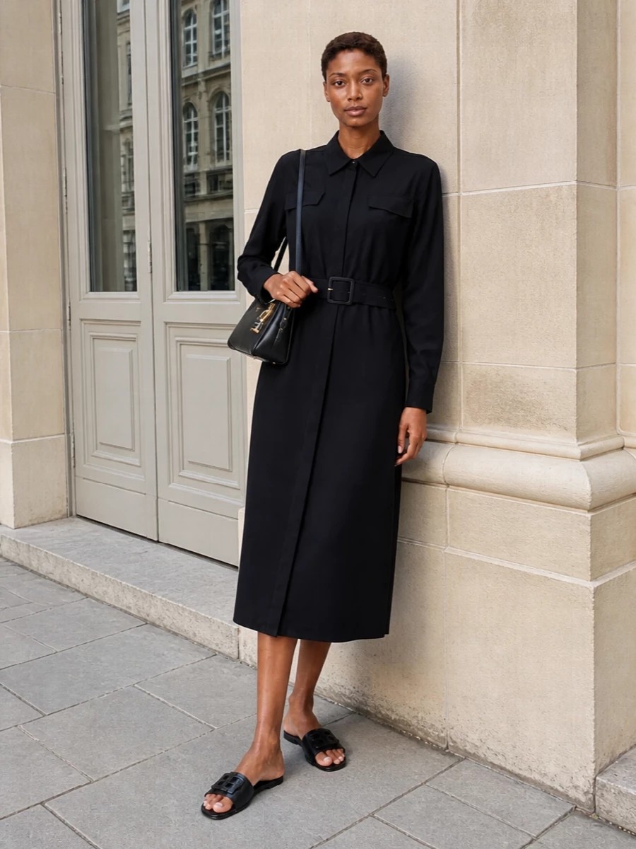 The ink-black shirt dress route feels more coherent with the Fendi slides than separates, echoing their tailored ease and letting the sculptural logo detail stay the focus at the hem. The belted waist and fluid midi length create a long, uninterrupted line, while the Prada shoulder bag keeps everything firmly in the quiet luxury space without breaking the monochrome mood. It is the kind of pared-back city ensemble that moves easily from office to understated drinks with only a jewellery change.