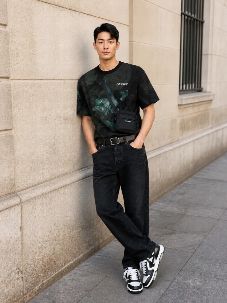 This look builds around the dark, painterly Off‑White tee with washed‑black straight jeans for a clean, urban line that keeps the focus on the artwork. Chunky monochrome sneakers echo the tee’s logo hits and add weight, while the compact black crossbody and structured belt bring just enough polish to keep the streetwear silhouette intentional rather than casual. It’s a tight, graphic SS uniform that feels directional but fully wearable day to night.